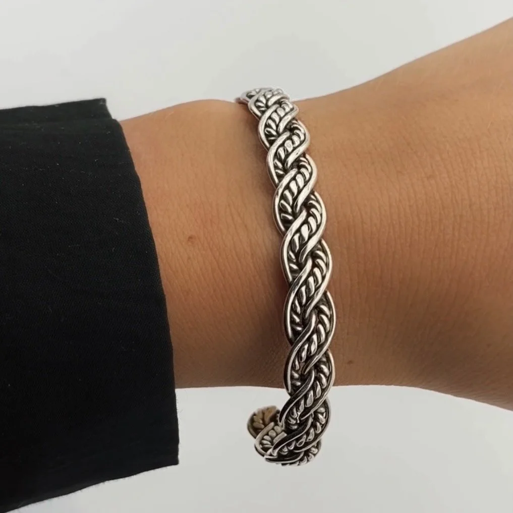 Silver cuff bracelet, inspired by ancient Viking era jewelry. The interwined parts of the bracelet give it an antique, vintage look.