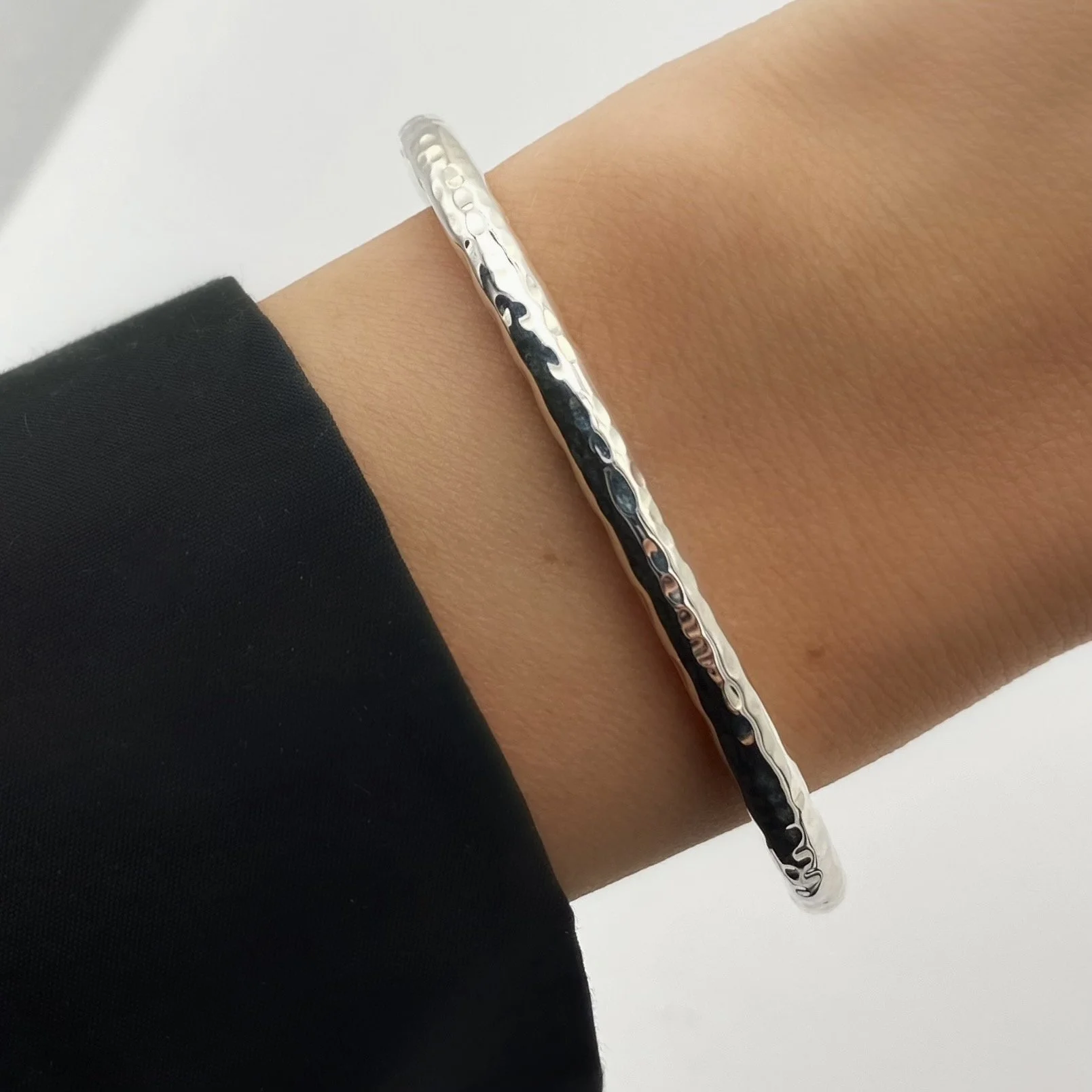 Round, open ended, cylindrical 925 silver bracelet. We took a minimalist style and made it interesting with a touch of texture.