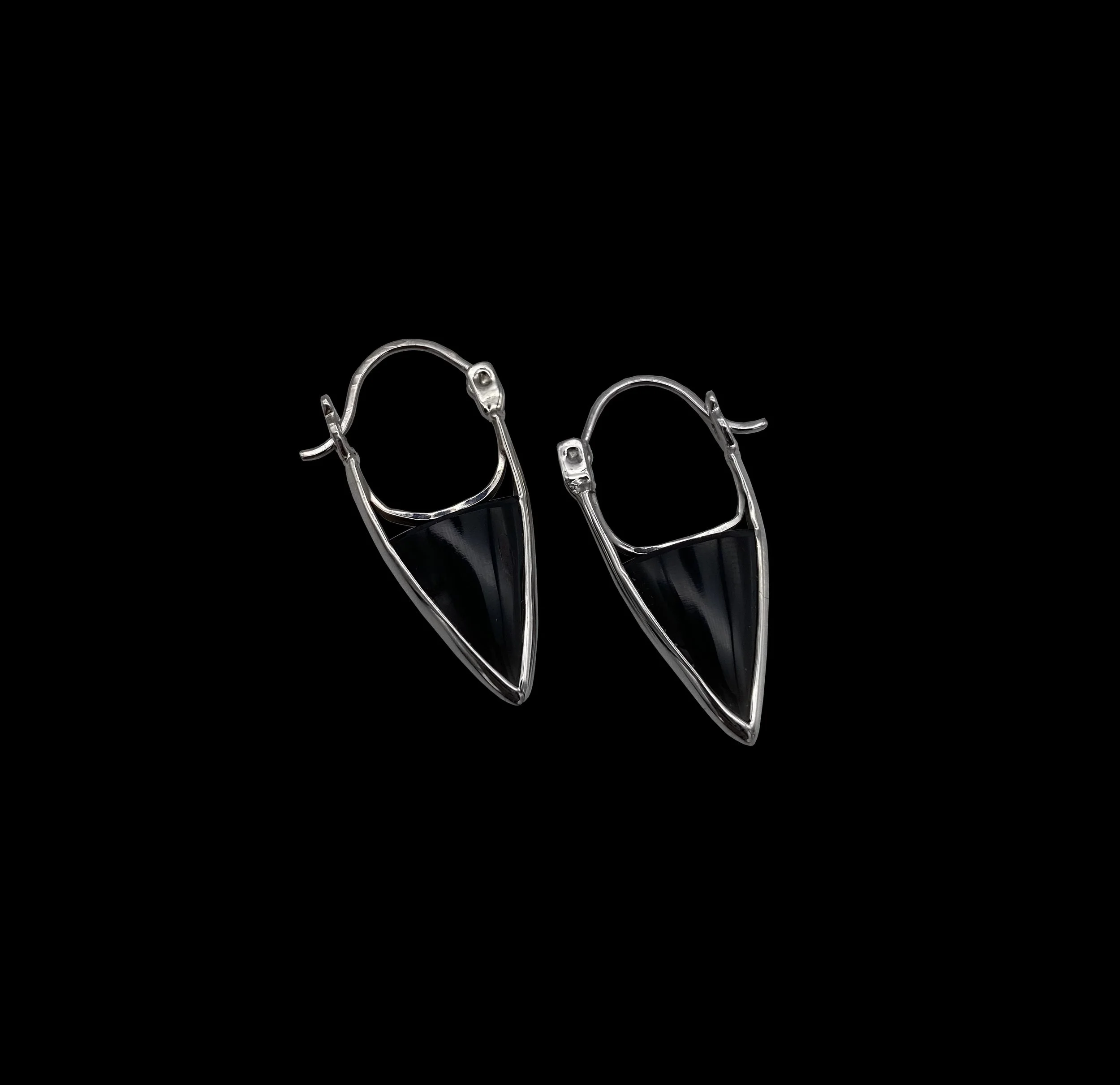 Versatile yet strong silver triangle-shaped earrings, decorated with onyx, can be worn with an elegant and sophisticated touch or an edgier way.