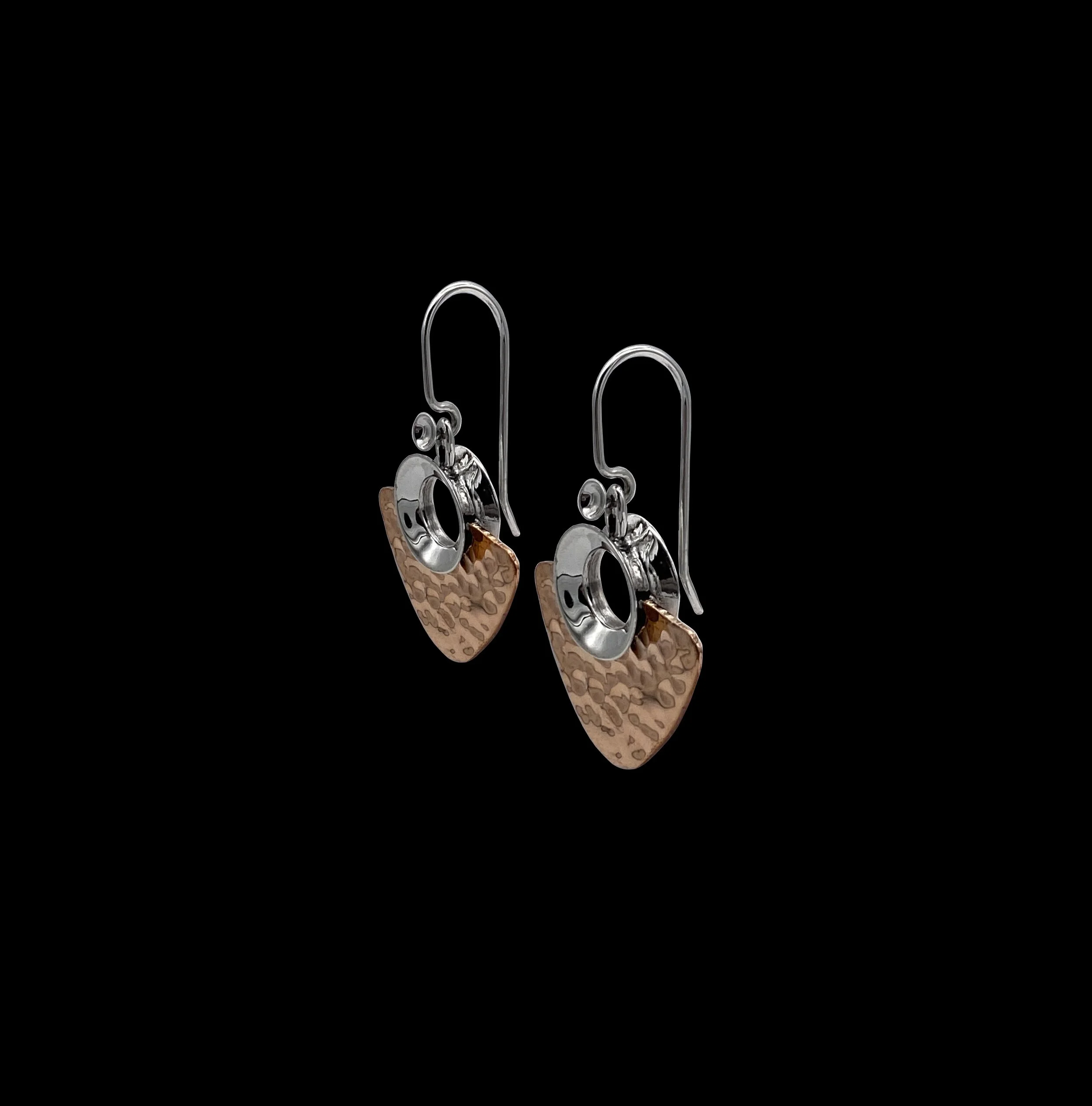 Fierce, tribal inspired, handcrafted earrings, created with high quality 925 silver and copper. The circle-shaped silver upper part supports the dangling, ribbed textured copper part.