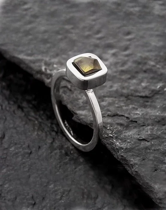 Minimalist thin classic shaped ring with small square part on top of it, which is adorned with faceted amber gemstone. Simple yet bright and effortlessly feminine.