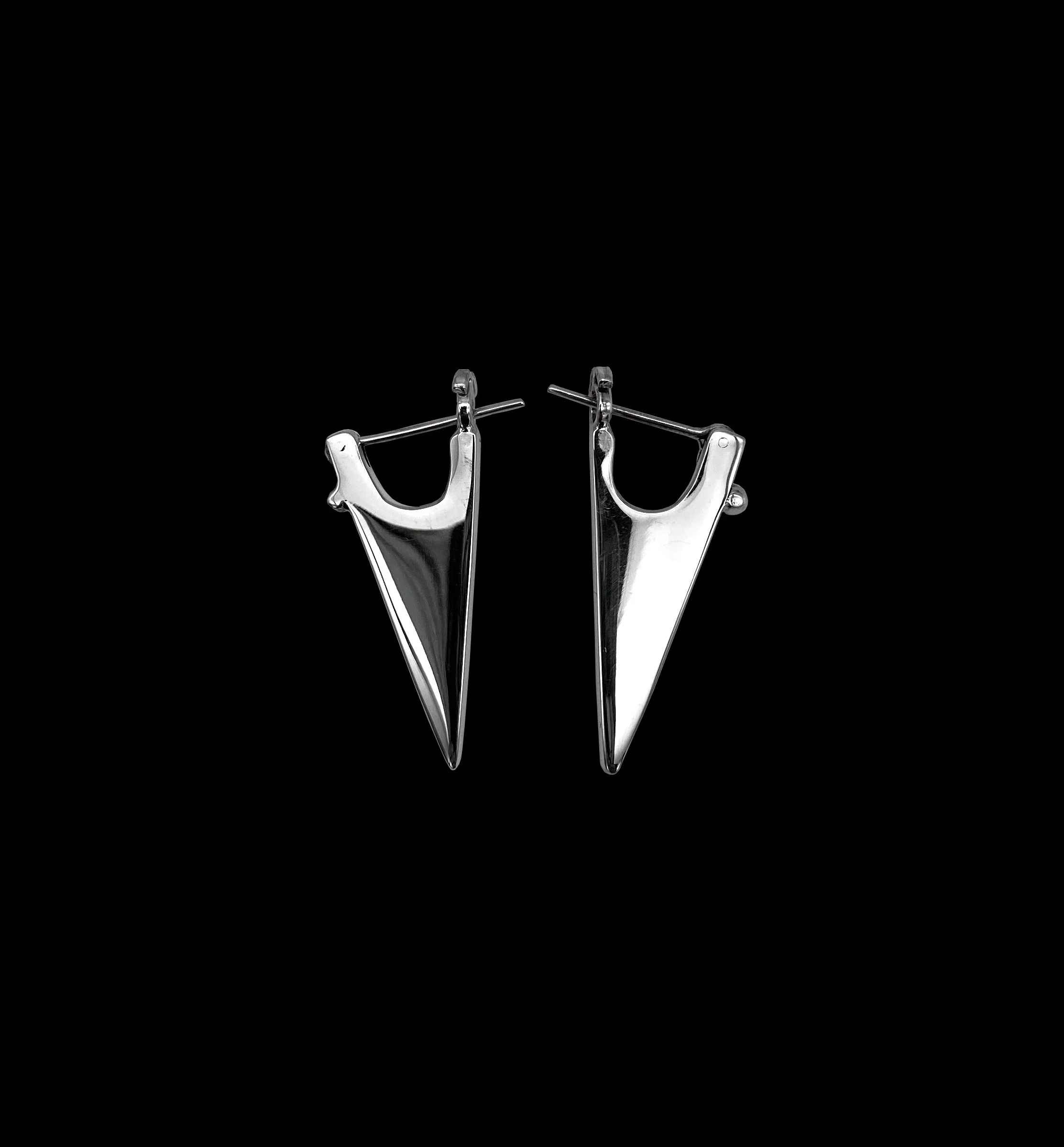 Bold, solid, triangle-shaped silver earrings, small enough for everyday look, yet fierce and edgy enough for night out.