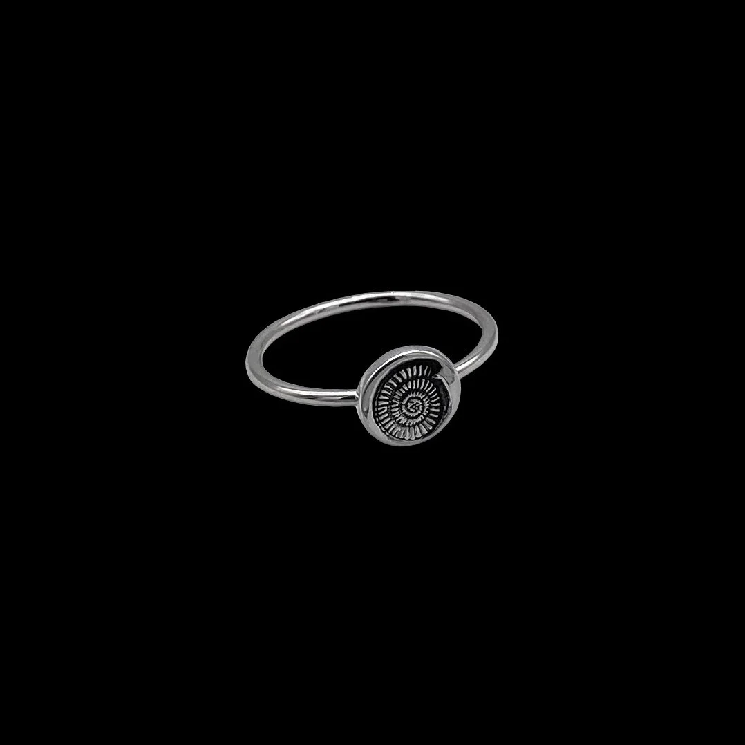 Minimalist thin silver ring, epitomising the spirit of the ocean. Contains round part with engraved seashell on it. Delicate everyday wear piece with a romantic, playful touch.