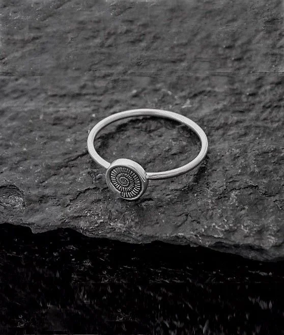 Minimalist thin silver ring, epitomising the spirit of the ocean. Contains round part with engraved seashell on it. Delicate everyday wear piece with a romantic, playful touch.