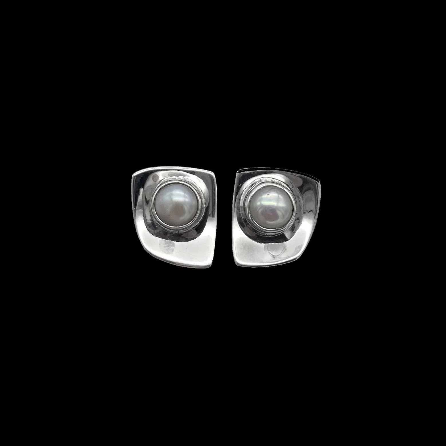 Uncommon square-shaped graceful silver earrings with rounded corners, decorated with shimmering pearl in the middle, as if lying on a platter. Luxurious and sensual.
