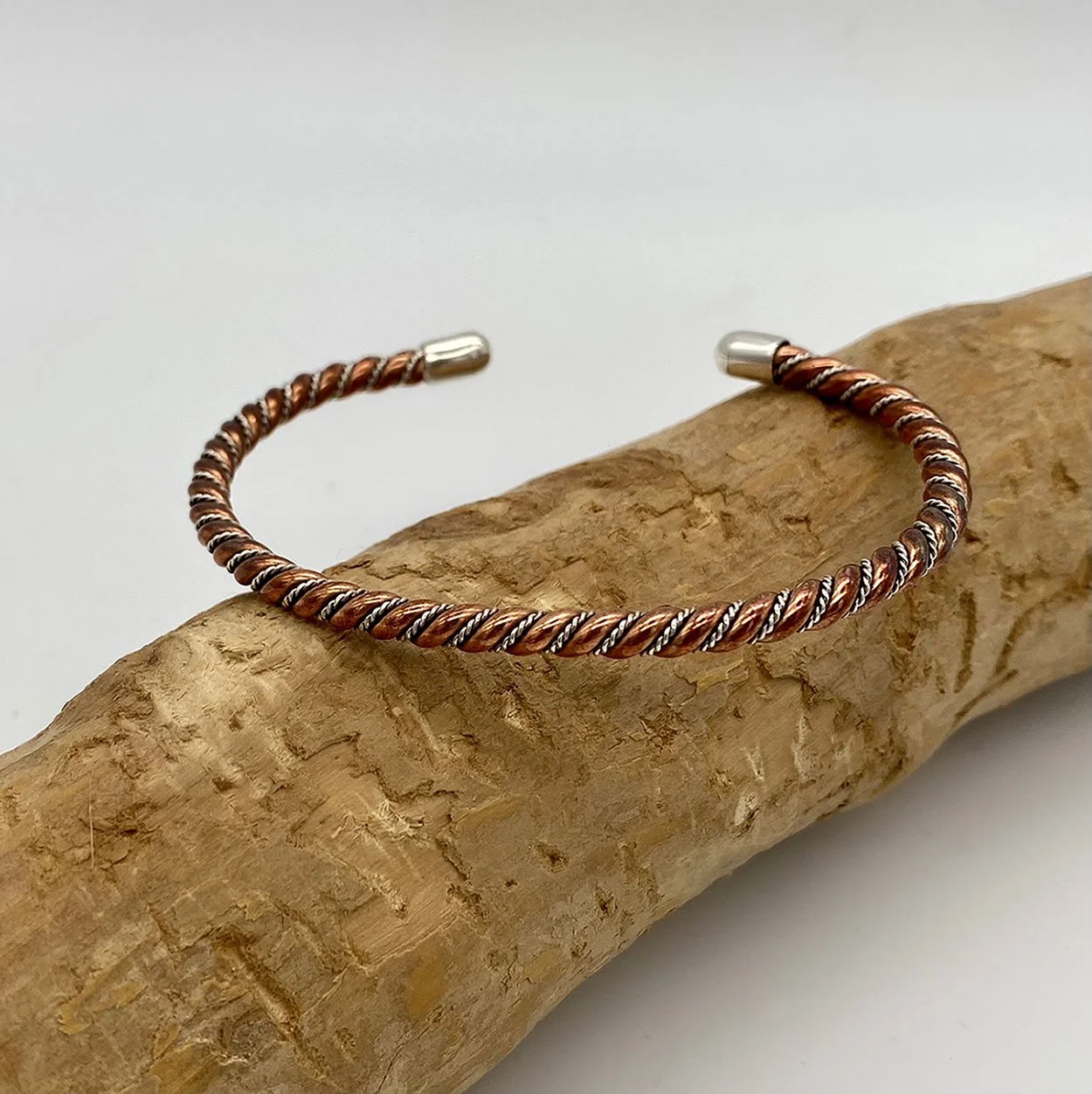 Fierce yet elegant cuff bracelet, created with interlaced 925 silver and copper. Inspired by the Viking era.
