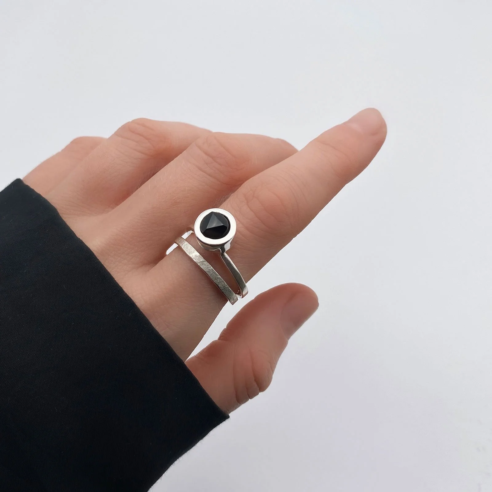 Piece, which contains two separate rings, which can be worn together as well. One is minimalist but the touch of texture and matte makes it special. Other is adorned with a faceted onyx on top of it.