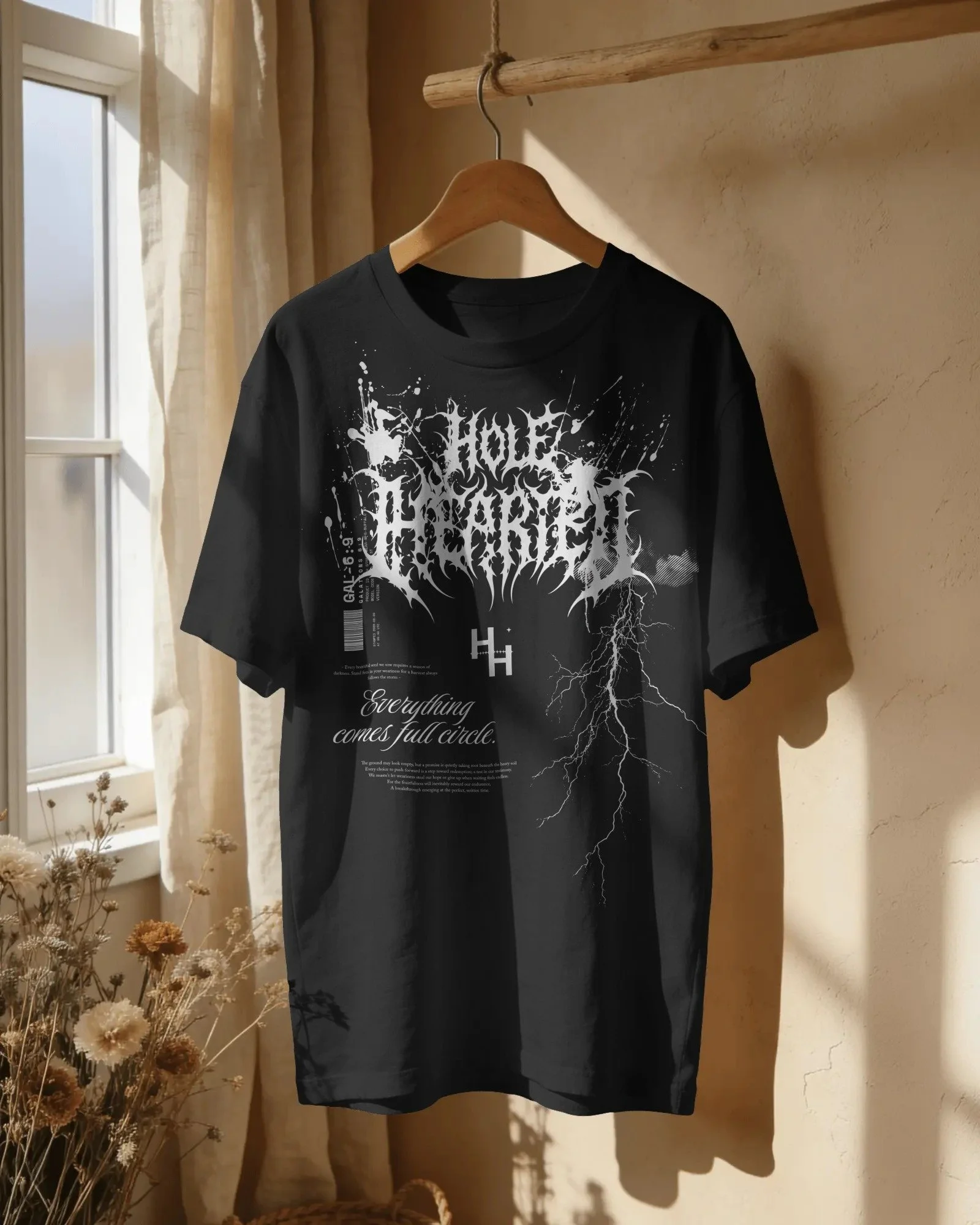 sunlit-window-t-shirt-mockup-hanging-on-wooden-hanger-with-soft-curtain-light-and-dried-flower-deco-04181.jpg