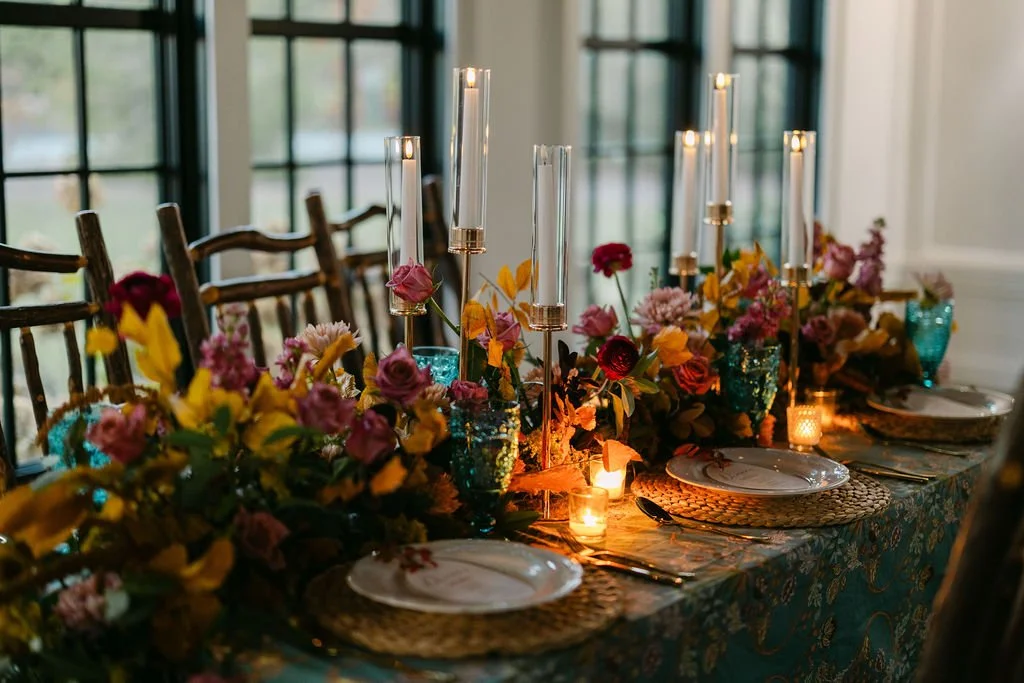 Color rich wedding reception florals with layered centerpieces and candlelight at the Village Green in Cashiers, NC