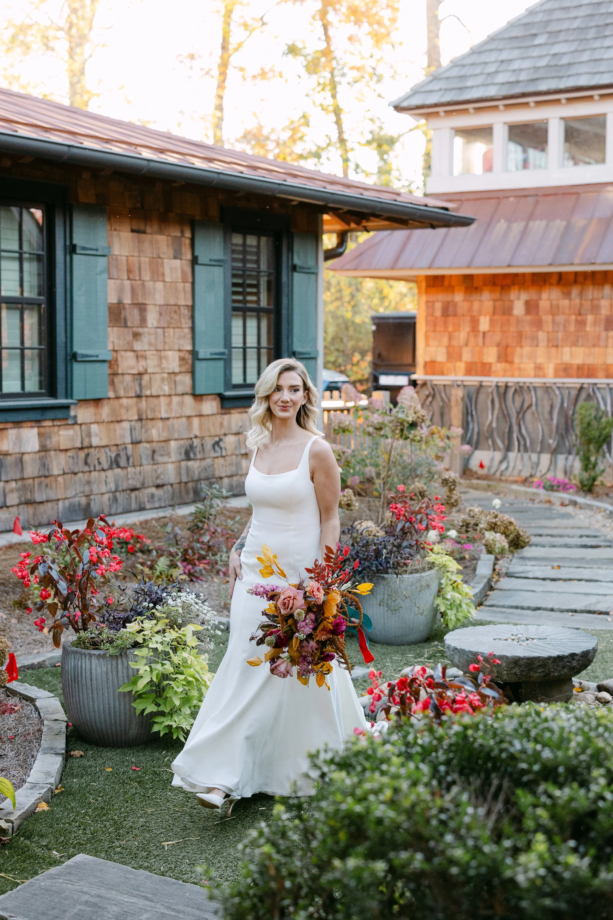 Bride with bouquet strolling through Cashiers, North Carolina's  Village Green