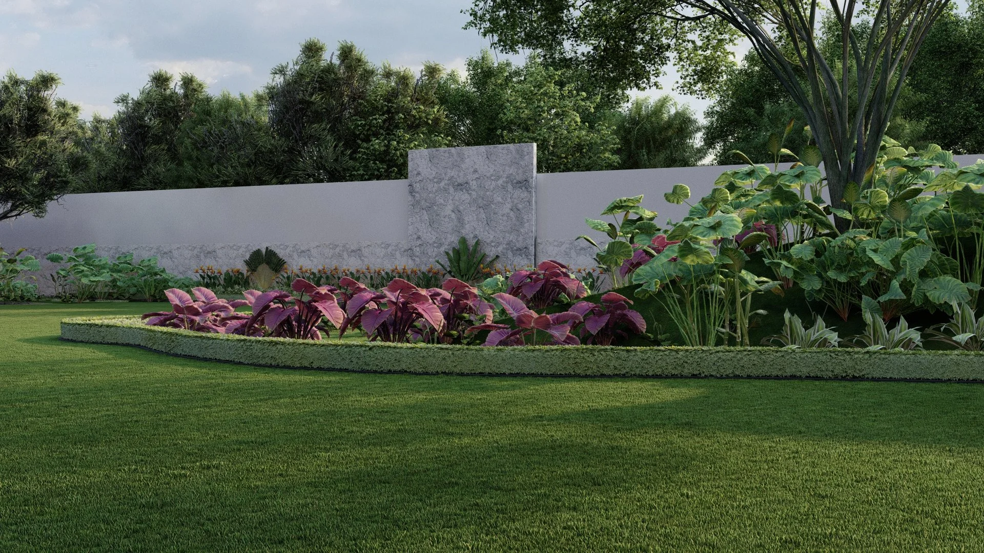 Jardín con césped, flores de colores brillantes y muro de piedra