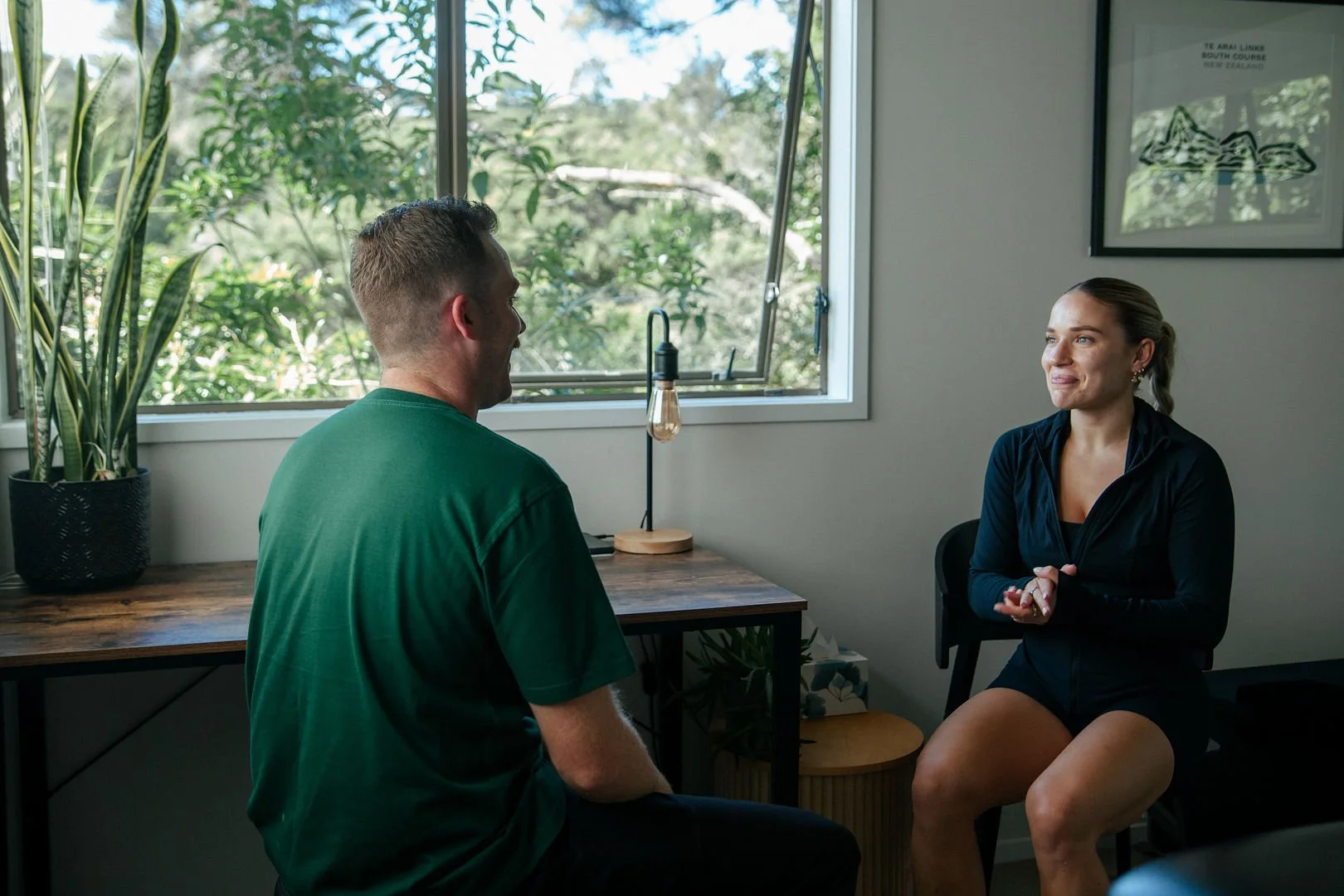 Physiotherapist talking with a patient during a consultation at The Physio Bunker, a physio clinic in Birkenhead