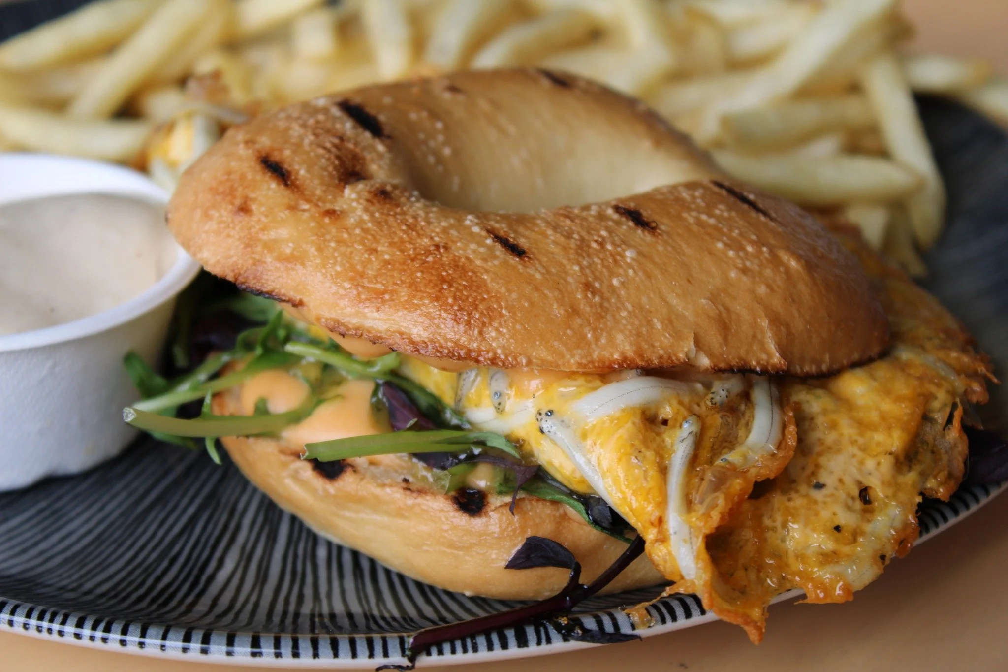 🌊👀 Up close and personal with the Best of the West! 

Have you tried our infamous Whitebait Bagel yet? A West Coast whitebait fritter nestled in a soft brioche bagel, topped with fresh mesclun, chipotle aioli, and served with a side of crispy shoes