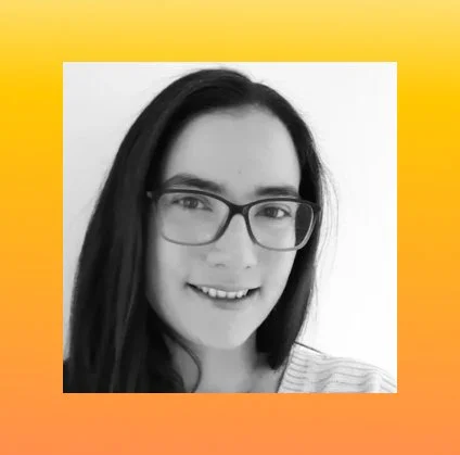 Headshot of Anna Hirschfeld - a white woman with dark hair and dark glasses