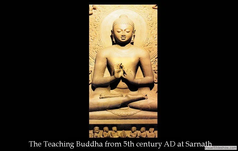 Stone statue of Buddha from the 5th century AD at Sarnath, depicted in a seated meditation pose with hands in a prayer gesture.