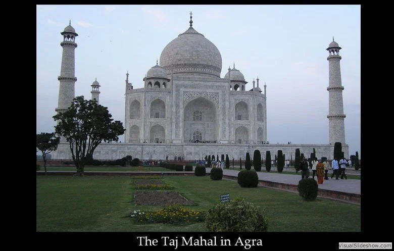 The Taj Mahal in Agra, a white marble mausoleum with a large central dome and four minarets at each corner, surrounded by gardens and visitors.