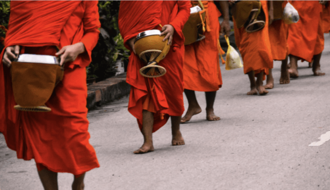 Ancient Indian rock-cut cave temples with intricate carvings and statues, bustling with visitors.