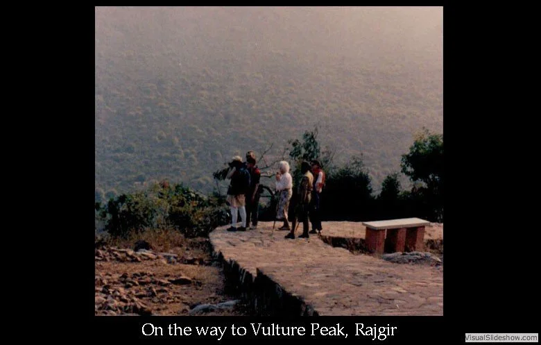 Group of people standing on a mountain path with scenic view in the background, heading to Vulture Peak in Rajgir.