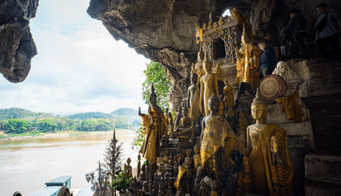 Ancient carved stone relief of a woman with jewelry, surrounded by other figures and detailed carvings.