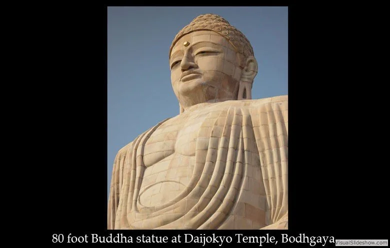 Close-up of the 80-foot Buddha statue at Dajokyo Temple in Bodhgaya, showing its serene face and detailed robes.