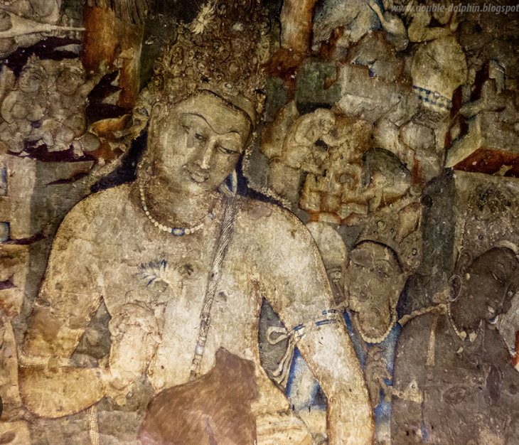 An ancient mural depicting women and children from Indian culture, featuring traditional attire and jewelry.