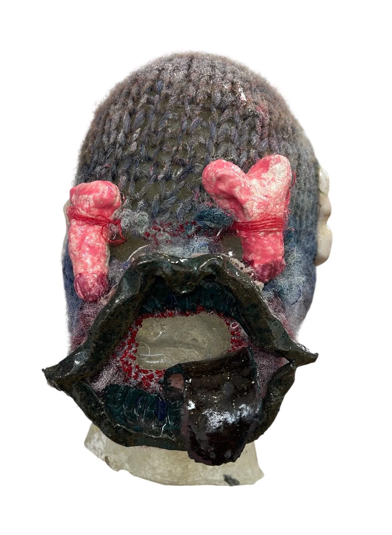  UNTILTED 
 Knitted mask
  27 X 17 X 23 cm 
 Alpaca thread, glazed ceramic, varnished salt doug
 2025