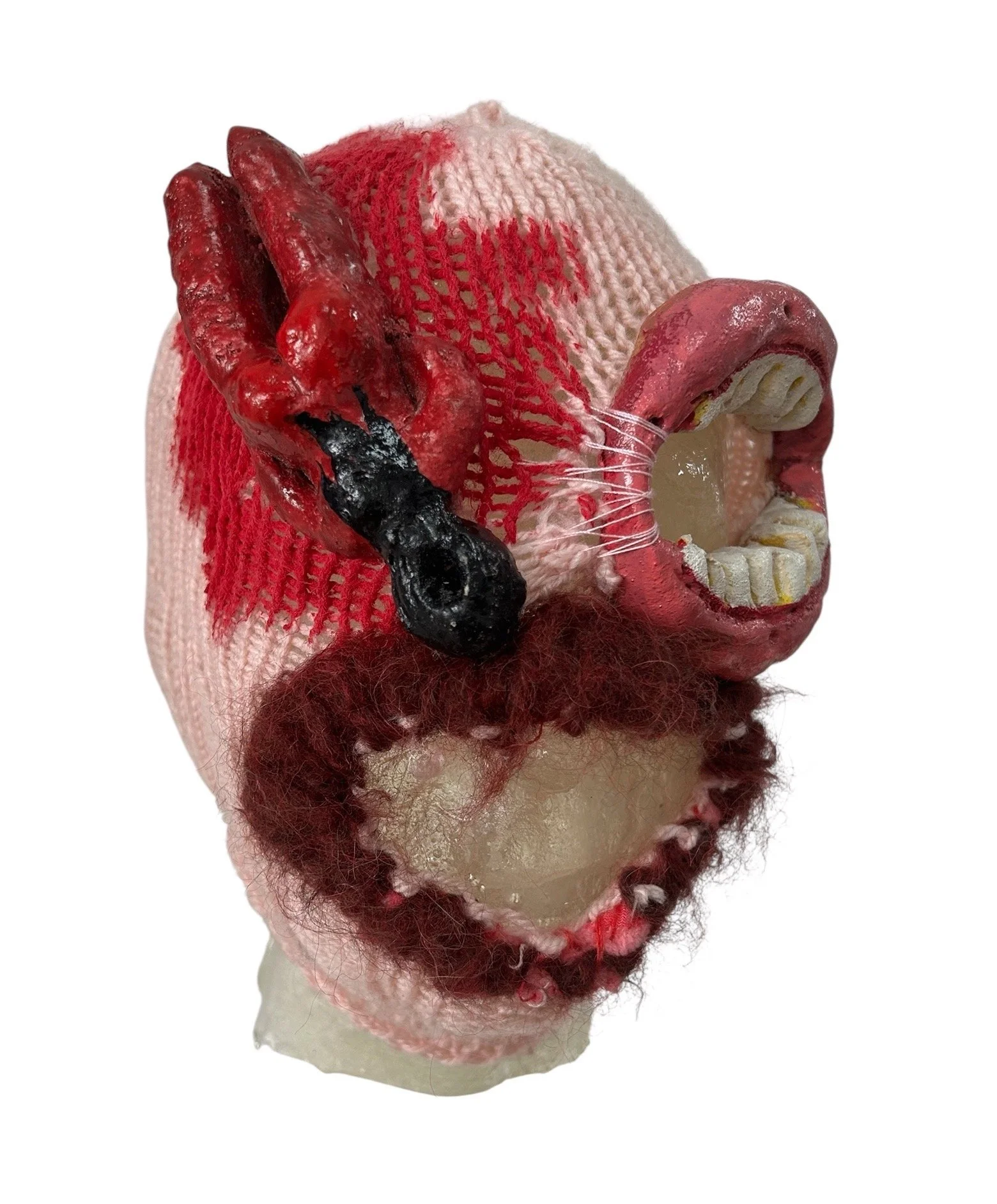  UNTILTED  
 Knitted mask
  27 X 17 X 23 cm 
 Wool, polyester, acyrlic paint, varnished salt dough
 2025