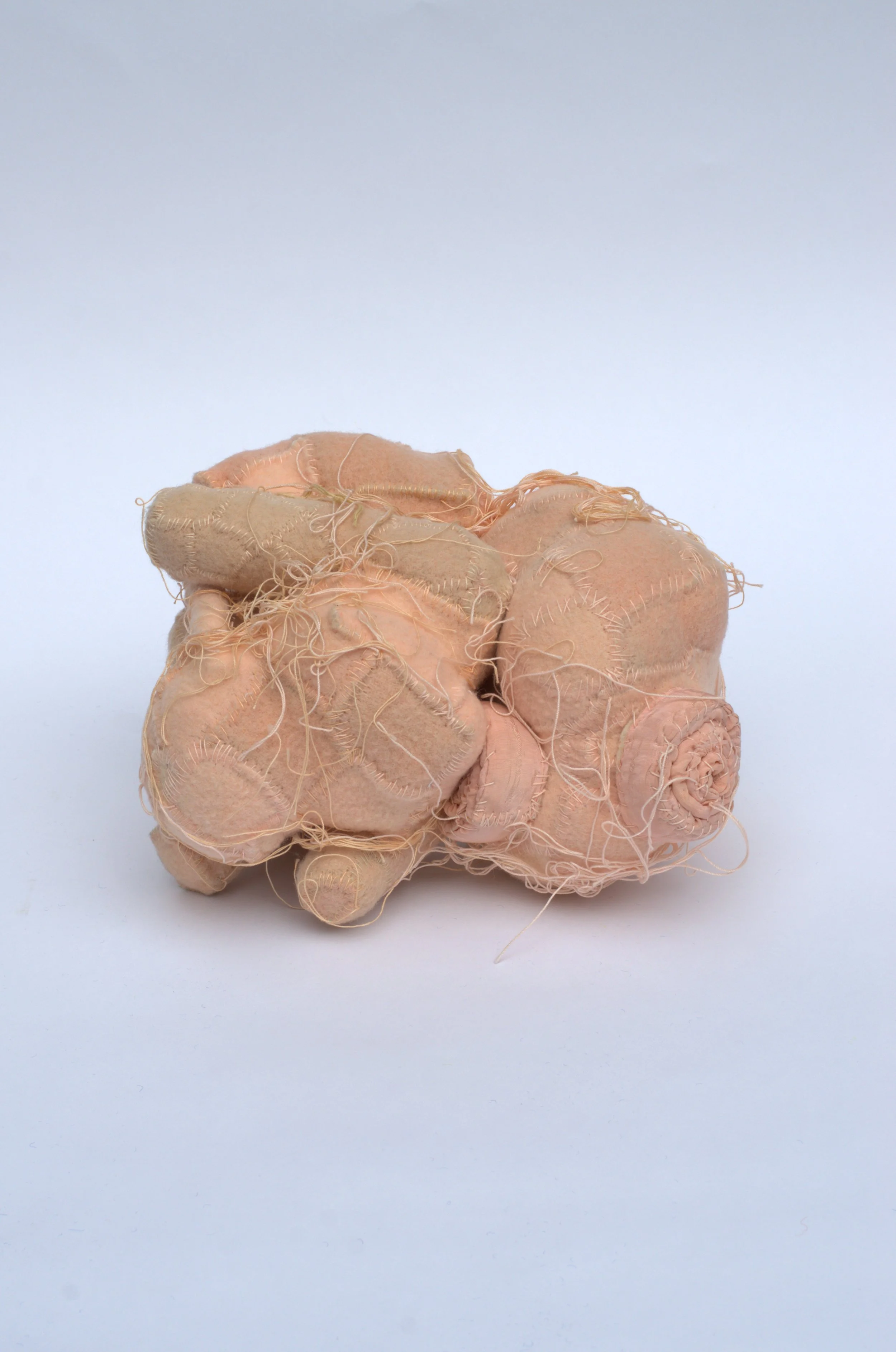  Kristina de Coninck 
 A newborn
 Created from washed and cut
vintage wool blankets, mattress
pieces and cotton threads
 33 × 33 × 23 cm
 2024