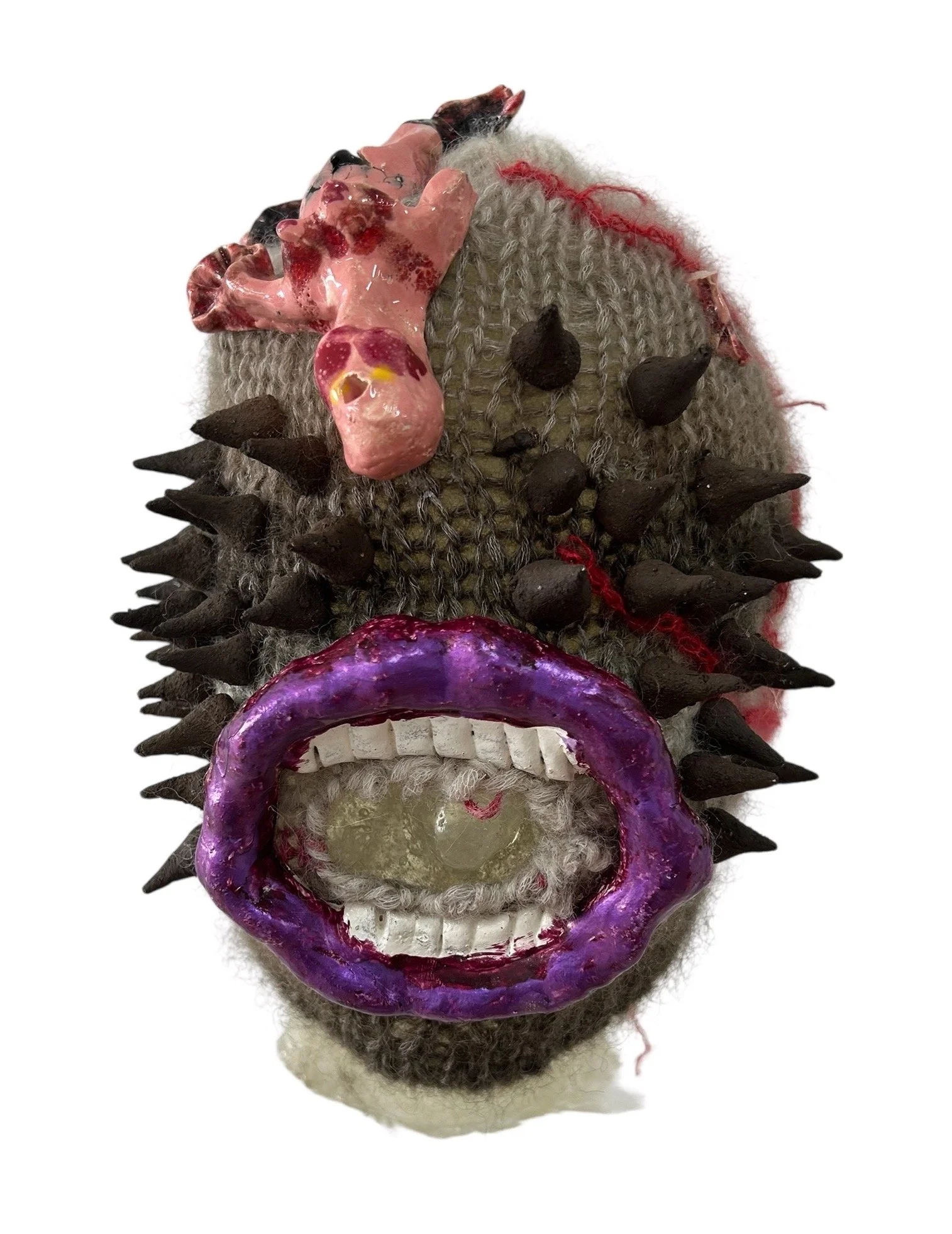  UNTILTED  
 Knitted mask
  27 X 17 X 23 cm 
 Alpaca thread, glazed ceramic, varnished salt dough
 2025