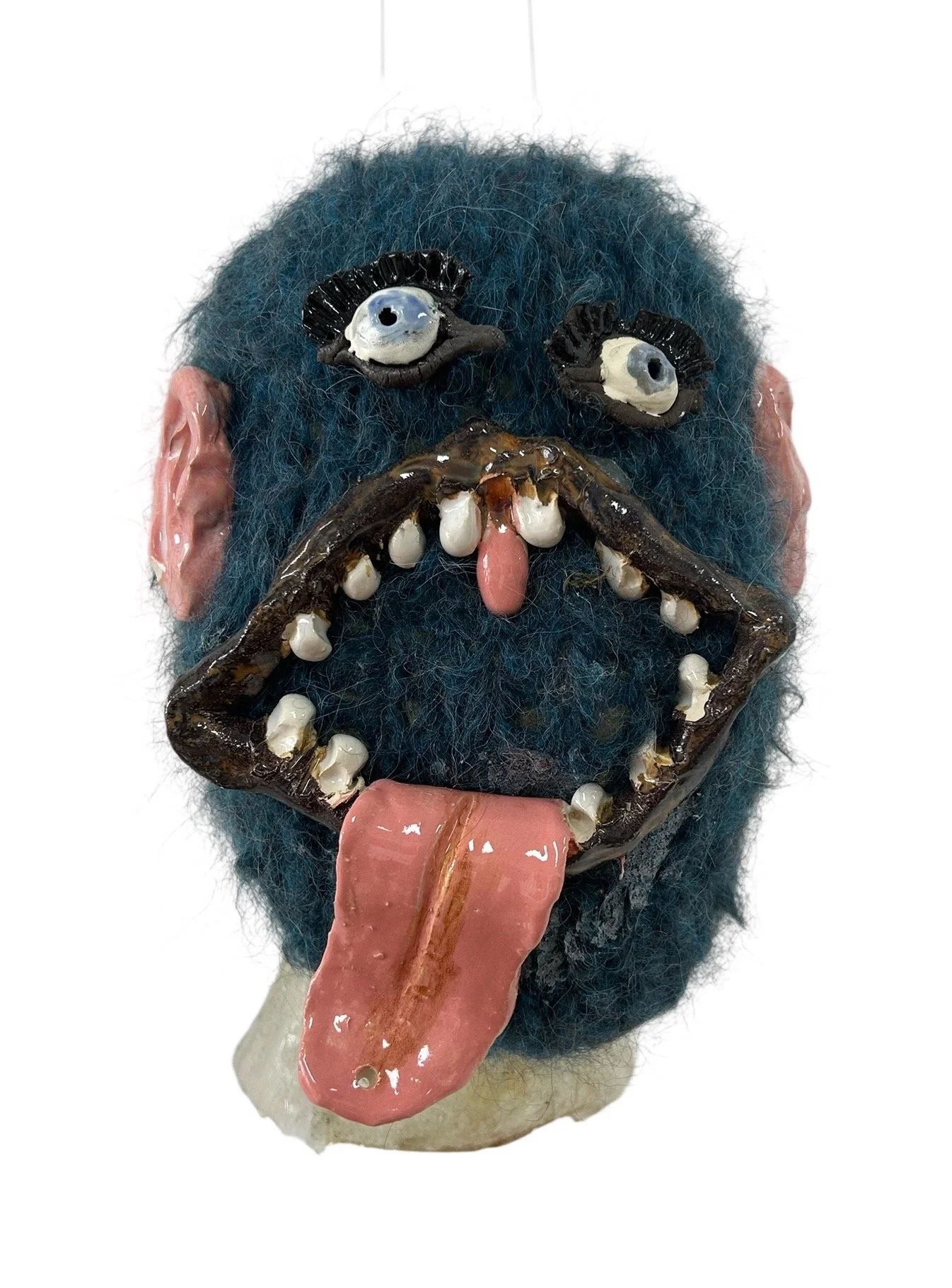  UNTILTED  
 Knitted mask
  27 X 17 X 23 cm 
 Alpaca thread, glazed ceramic
 2024