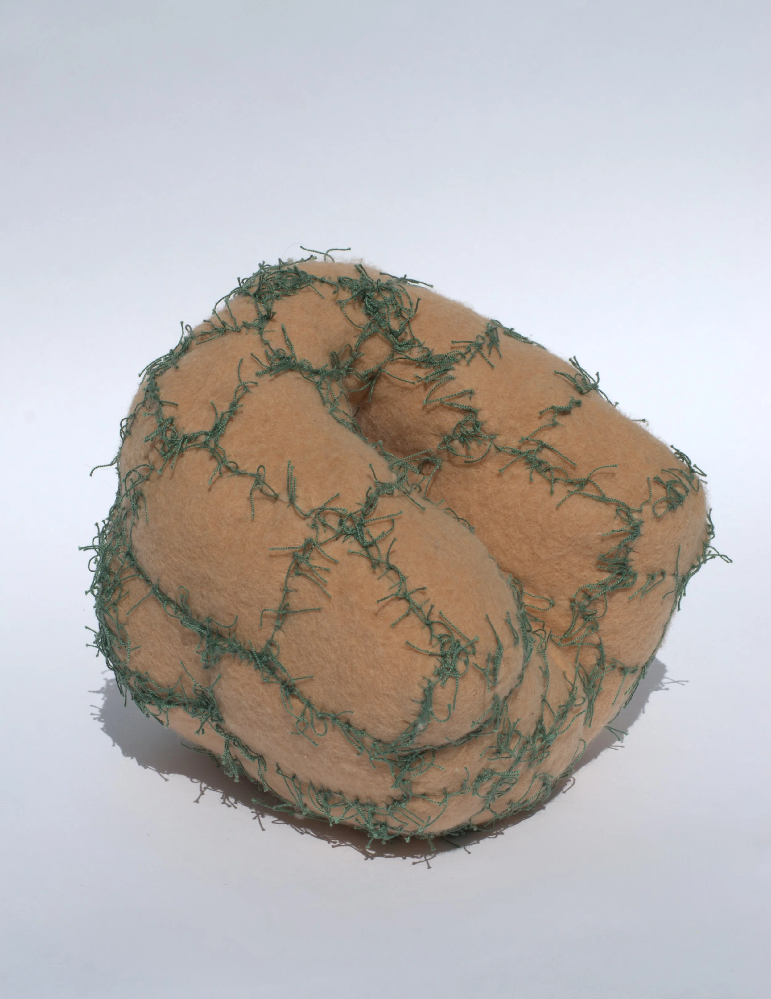  Kristina de Coninck 
 It’s own rhytm
 Wire-framed sculpture, coverded
with washed and cut wool blankets
and cotton threads
 31 × 35 × 35 cm
 2024