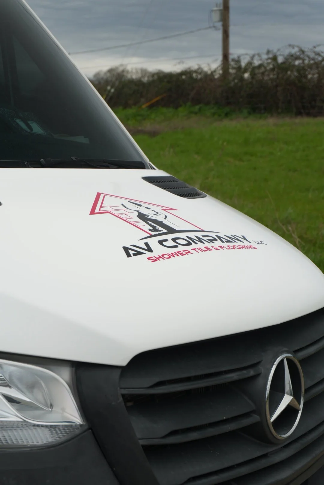 mercedes sprinter van hood wrap with company logo. includes a custom design logo for flooring and tile company wrapped whole hood in gloos white avery dennison material wrap in salem oregon 
