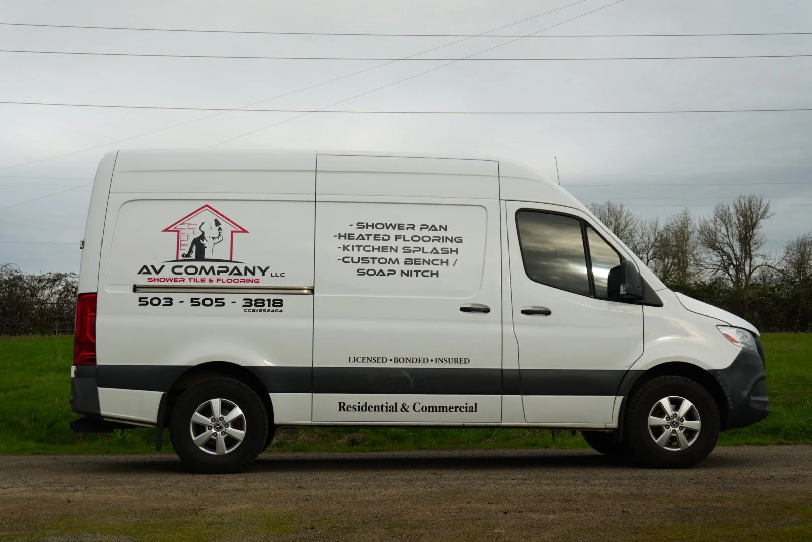 White service van parked on grass with business information and logo for AV Company LLC on the side. customer requested best wraps in salem oregon good wraps in salem oregon