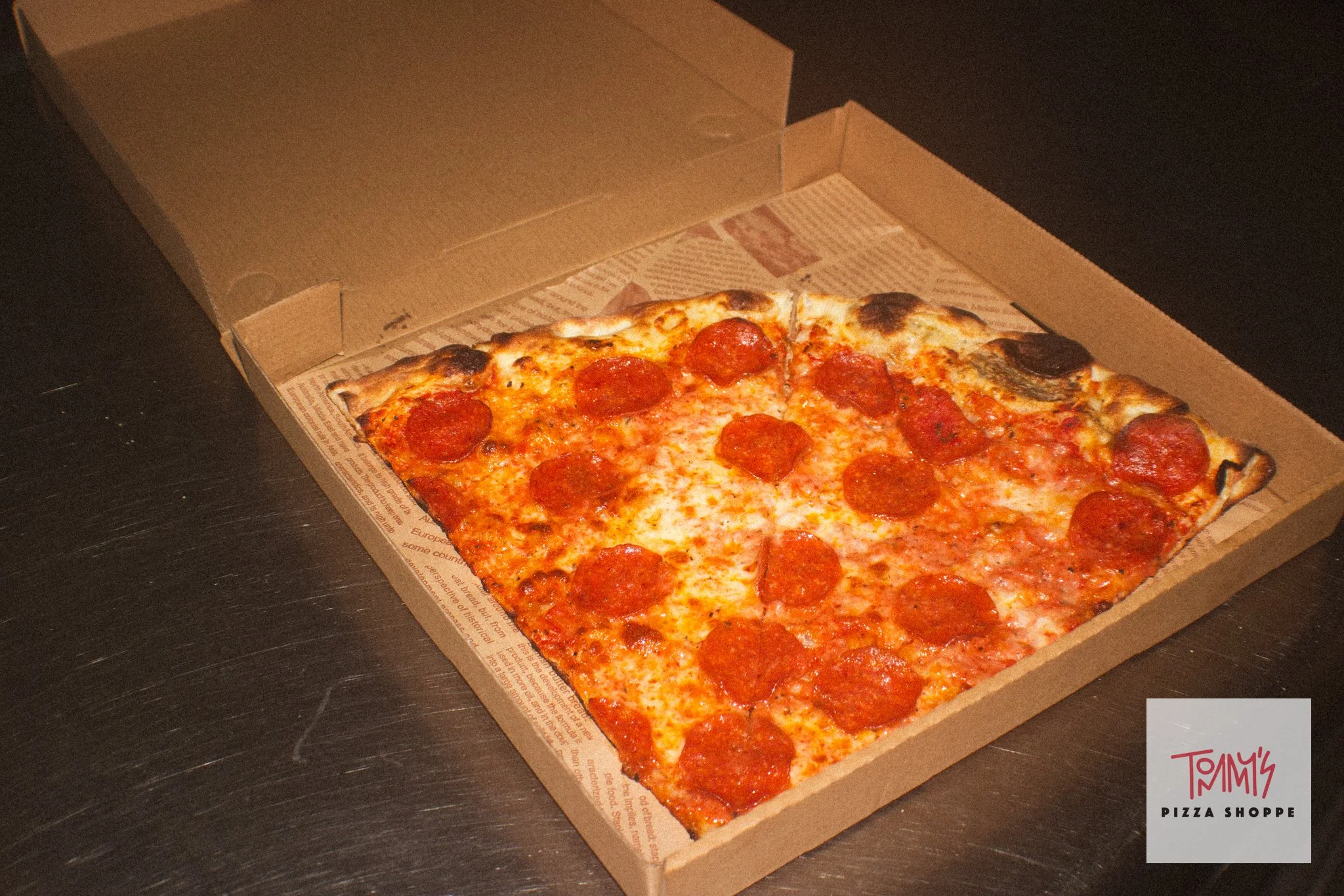 Classic pepperoni New York-style pizza baked in a deck oven at Tommy's Pizza Shoppe in Guam.