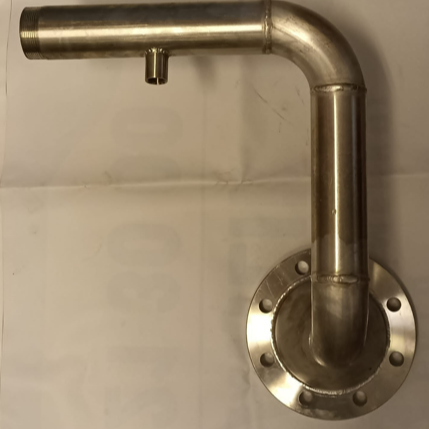 Metal pipe with a flange mounted on a wall, with an upward turn and a small horizontal extension at the top.