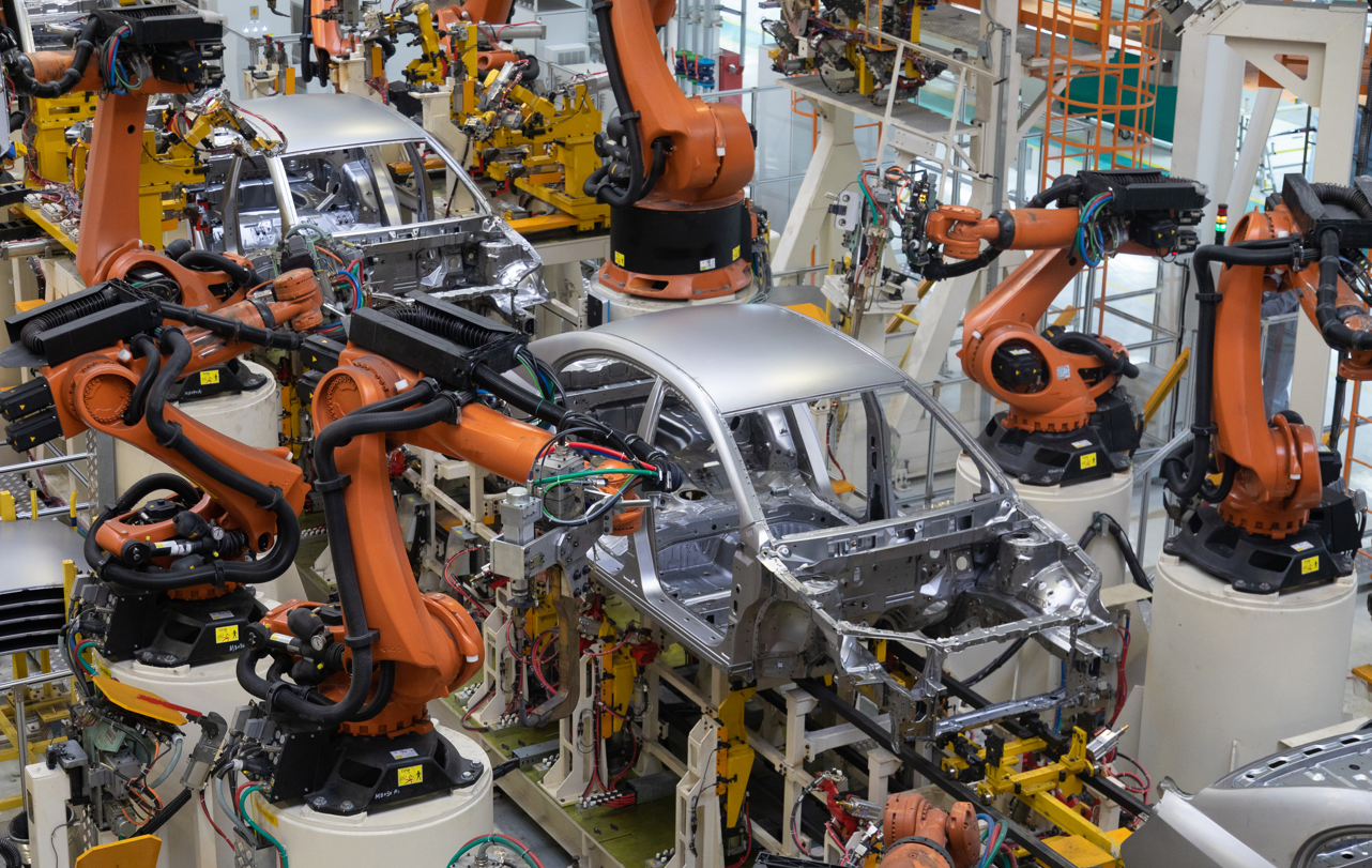 Robots assembly car bodies on an automotive production line.