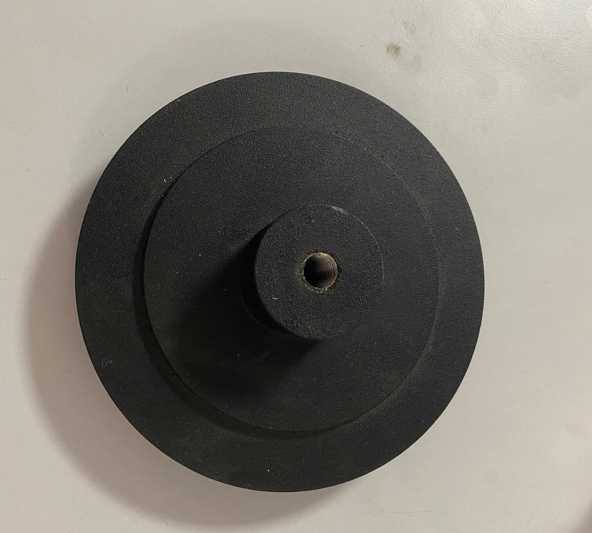 A black weight plate with a central hole, likely used for weightlifting or exercise.