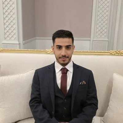 Digital illustration of a faceless person with short black hair wearing a blue shirt, against a light blue background.