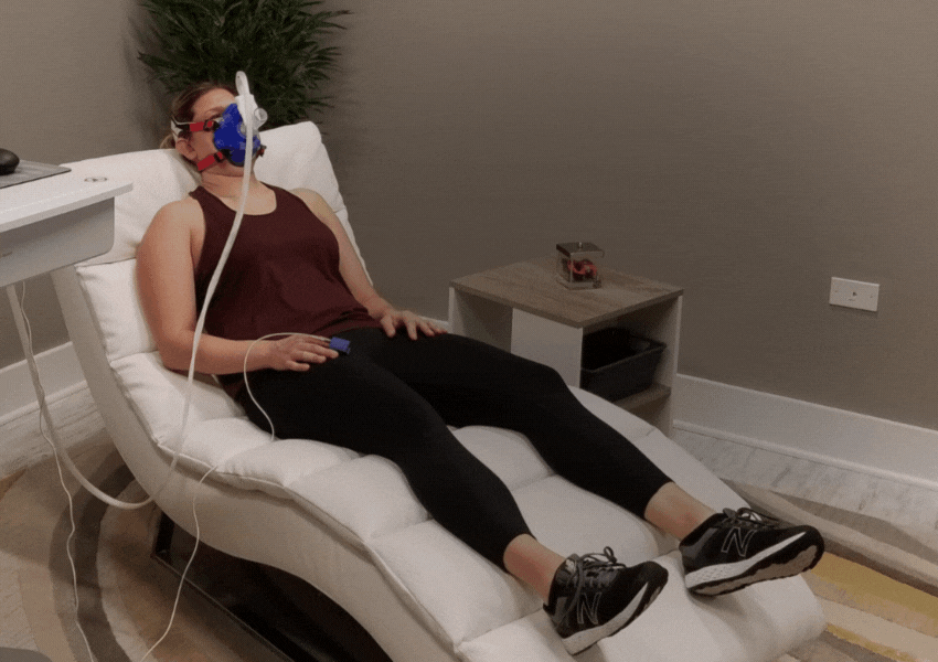 woman getting rmr test at dexafit with stats