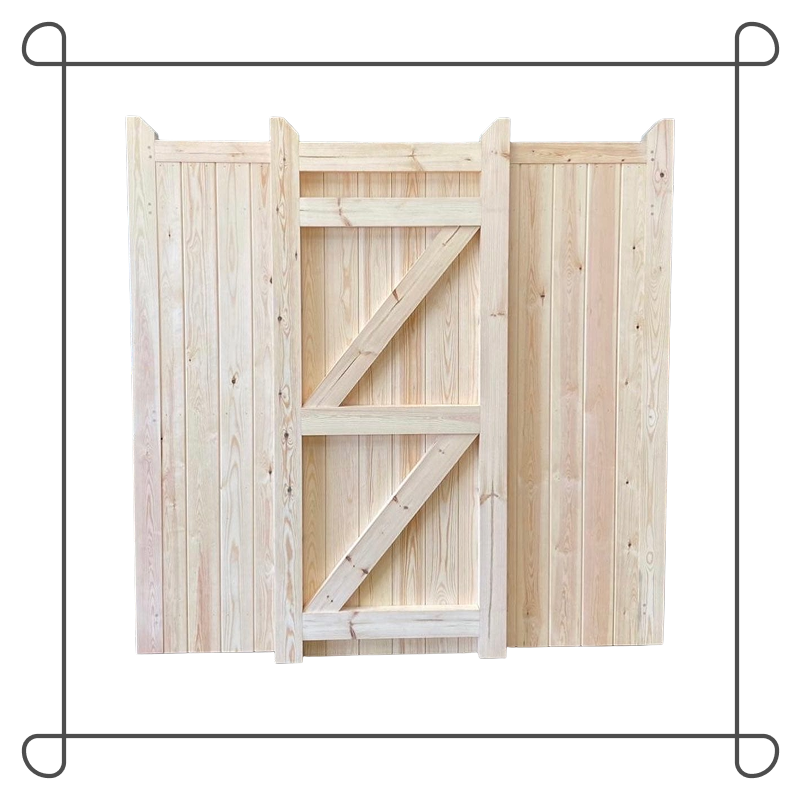 Wooden gate with brick pillars in front of a house with a red-tile roof and dormer windows, surrounded by greenery and trees.