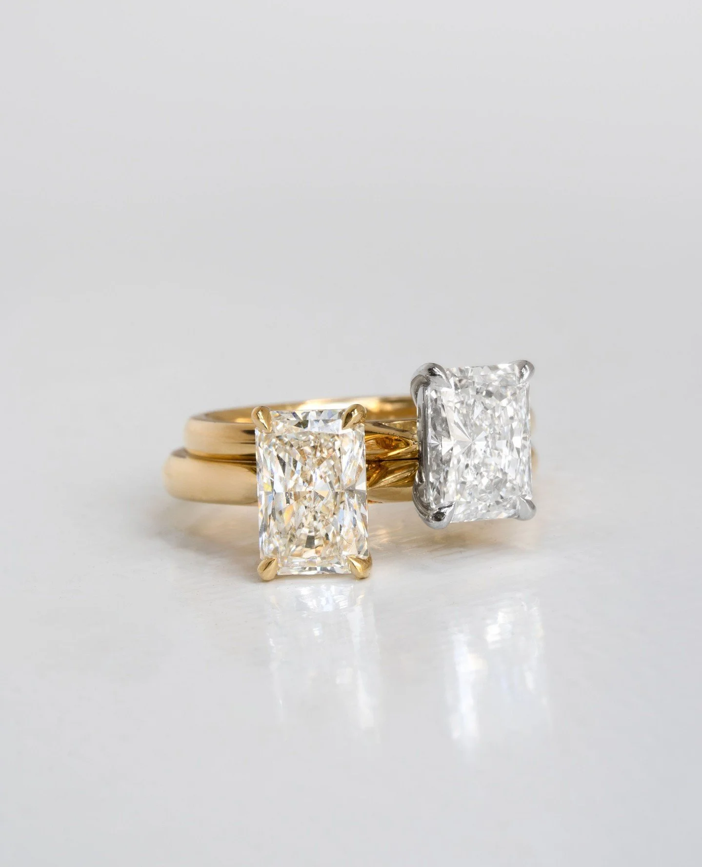 Two identical 1.5ct radiant cut solitaires, crafted two ways. One entirely in 18ct yellow gold. The other with a yellow gold band and platinum setting.⁠
⁠
The white platinum keeps warmth away from the stone, so the diamond stays icy and bright.⁠
⁠
Tw