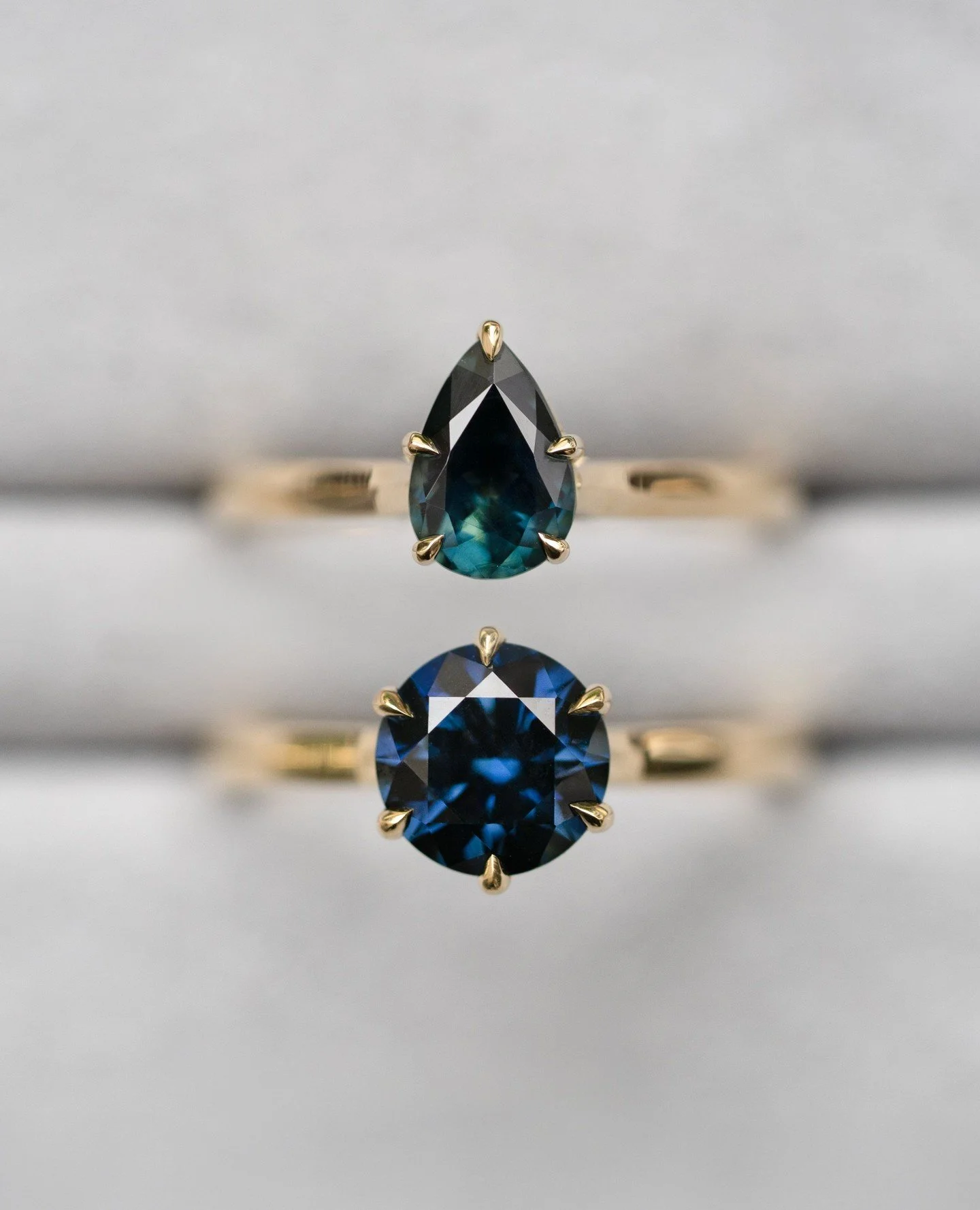 Two Australian sapphires, one hand fossicked the other carefully selected from a local family run miner. Known for their deep, inky blues with flashes of teal, they&rsquo;re like little galaxies suspended in time &mdash; small worlds, born undergroun