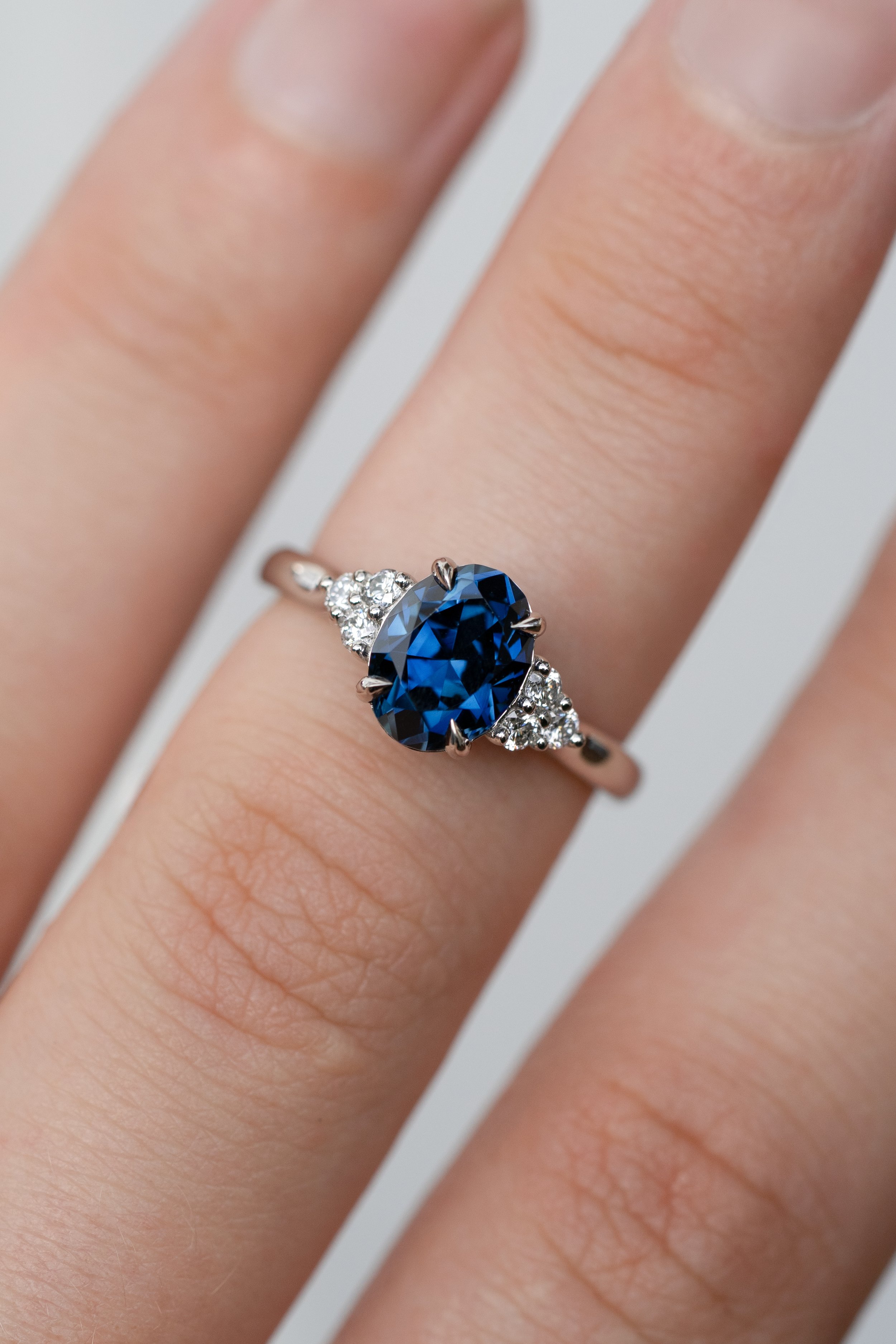 Vibrant blue Australian Sapphire with natural diamond cluster shoulder stones