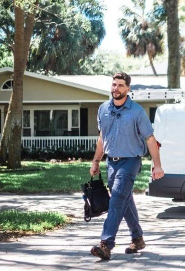 HVAC Expert in uniform walking to do a AC repair job