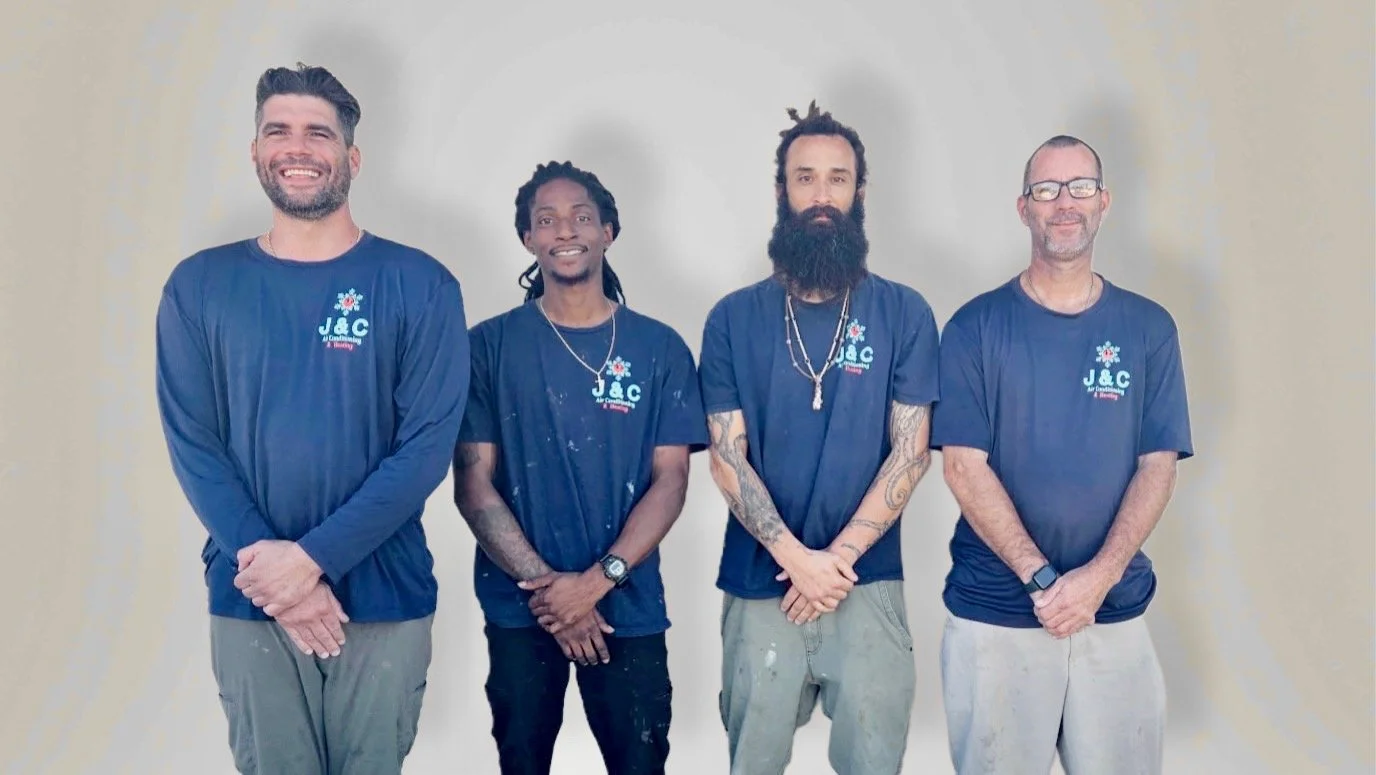 four HVAC workers standing side by side