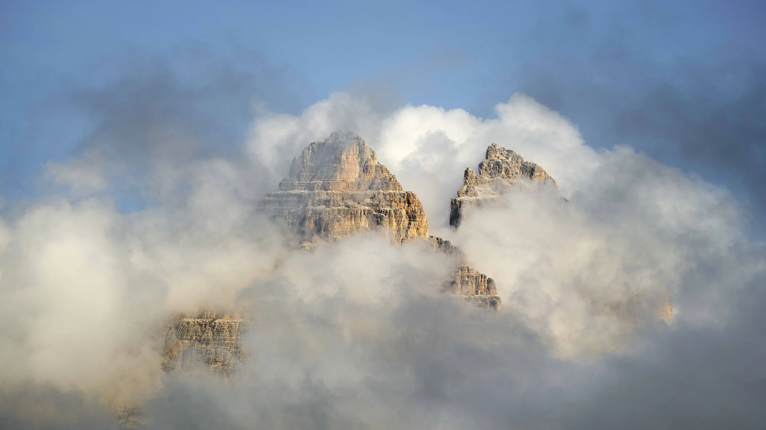 Mountain peaks partially obscured by clouds and mist.