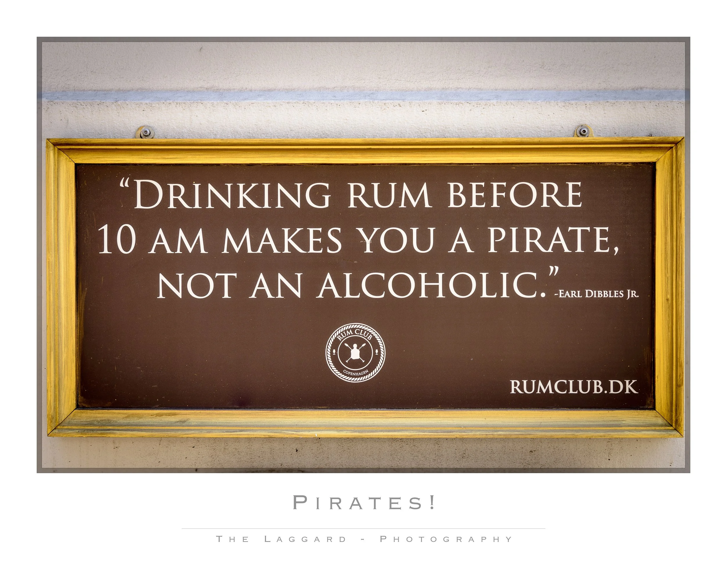A sign with a humorous quote about drinking rum and pirates, from Earl Dibbles Jr., and the website RUMCLUB.DK.