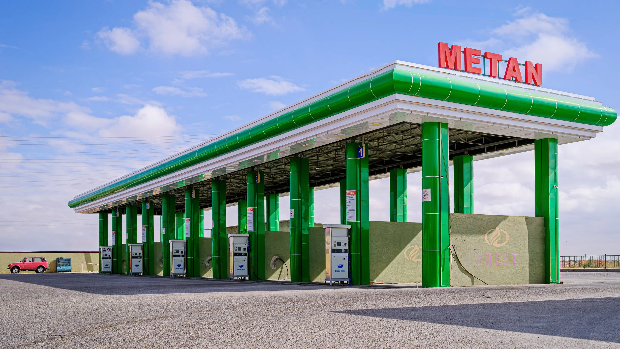Green gas station canopy with red 