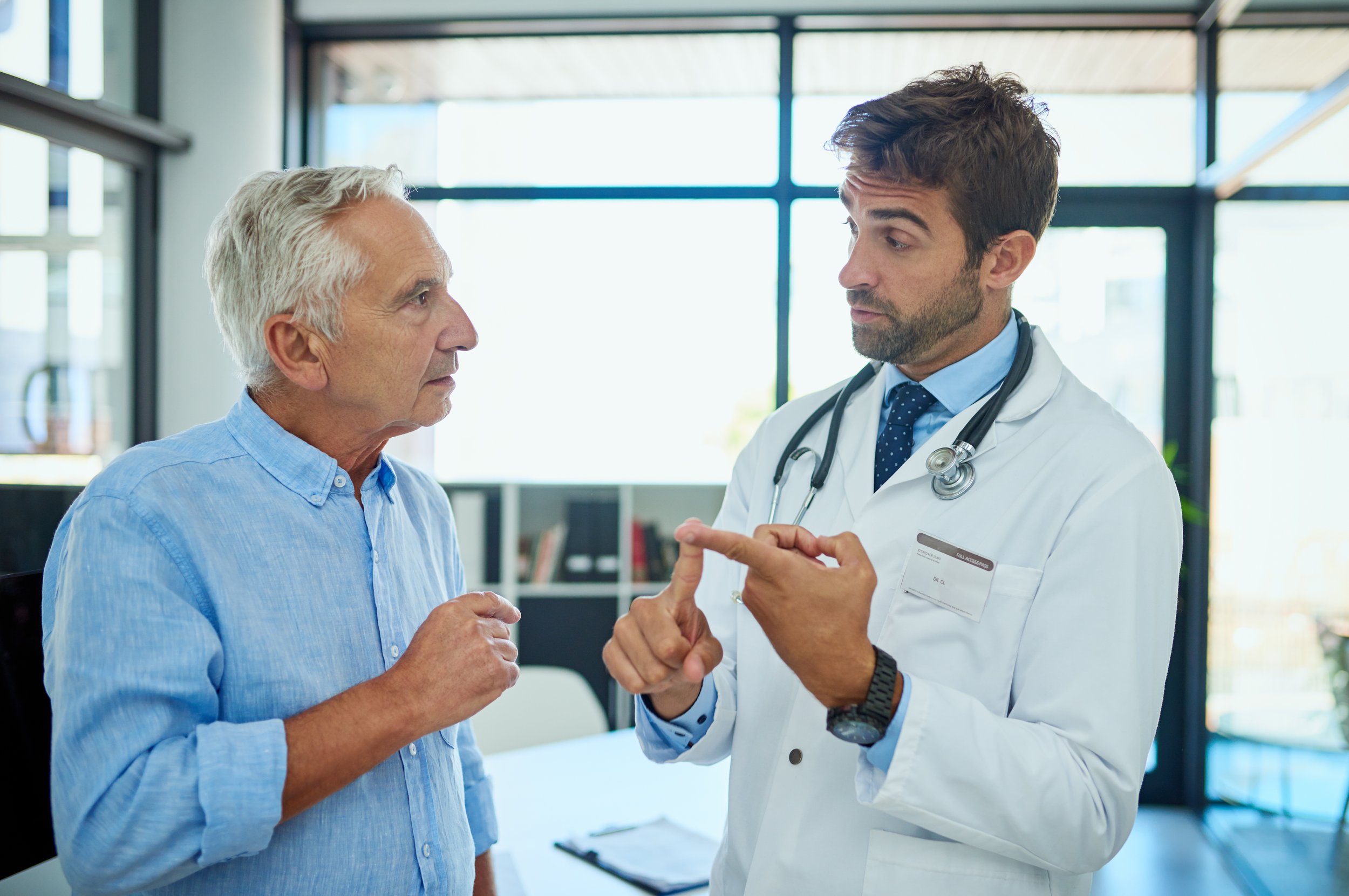 Man healthcare worker communicating with male patient
