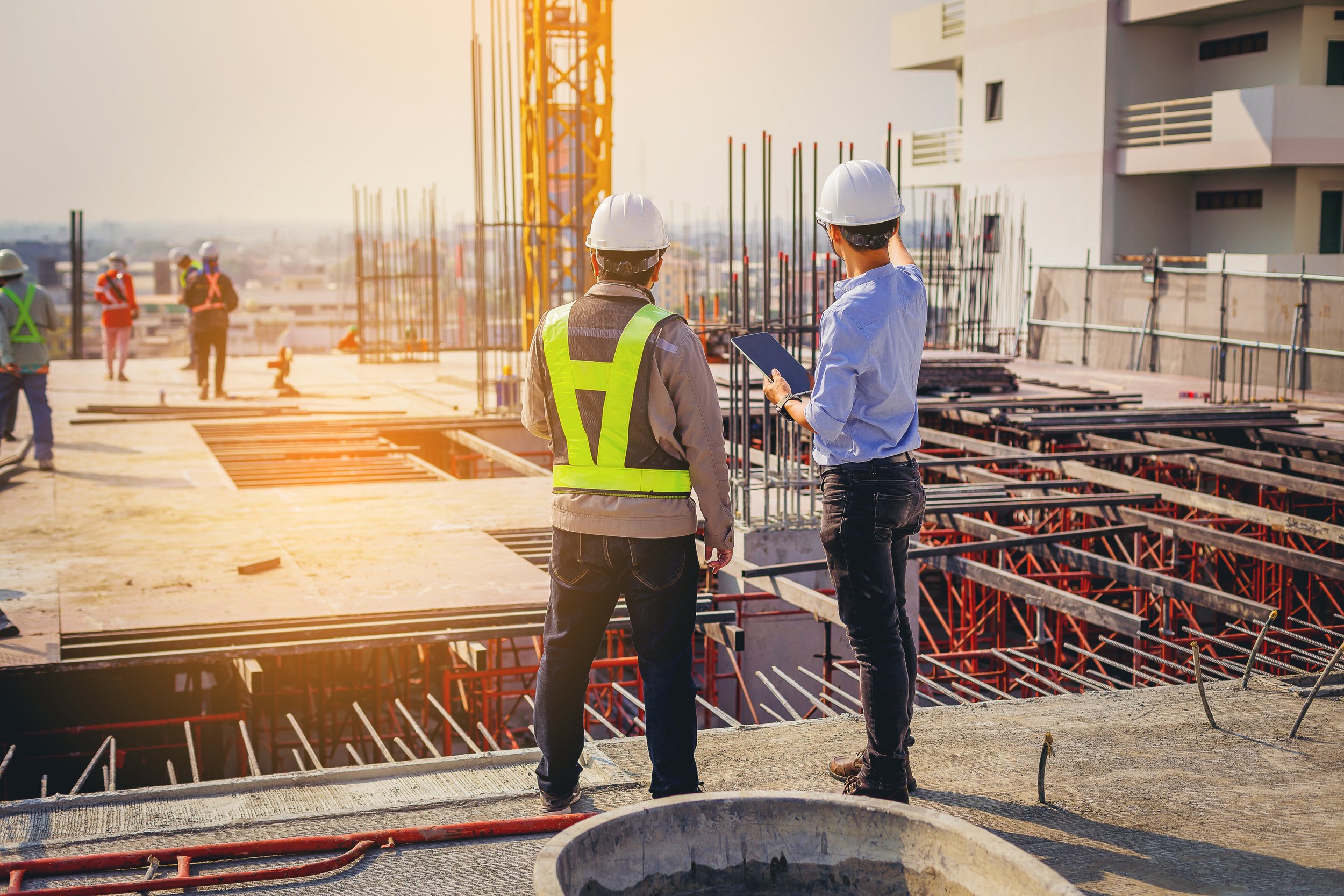 Project manager on a job site communicating with a construction worker